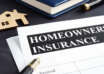 Homeowners insurance policy and model of home.