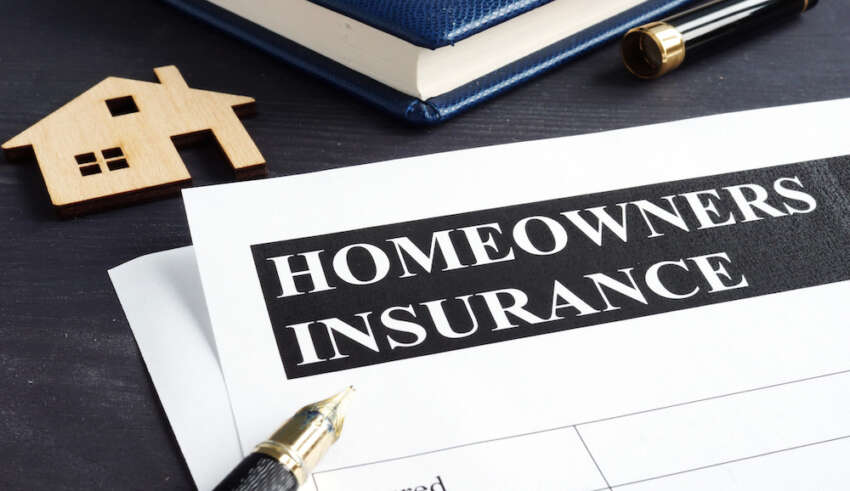 Homeowners insurance policy and model of home.